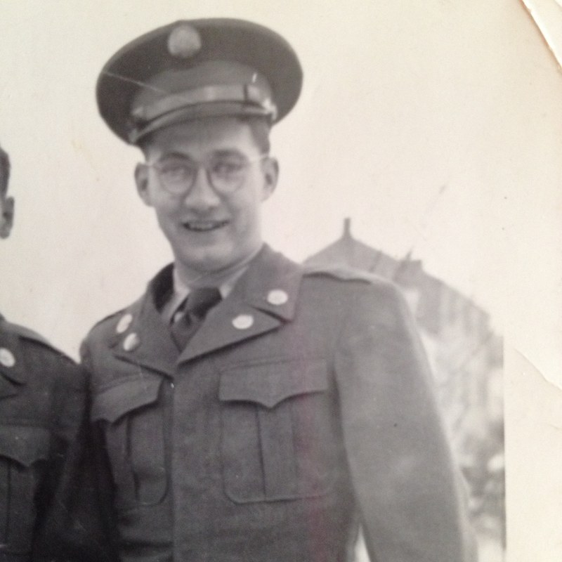 A smiling young man in a vintage military uniform