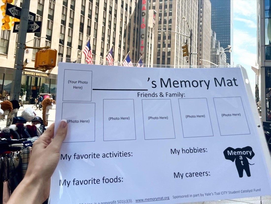 A blank Memory Mat held up on a New York City street