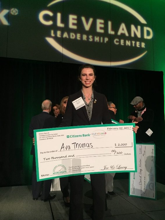 Ava Thomas holding a $2,000 grant check at the Cleveland Leadership Center